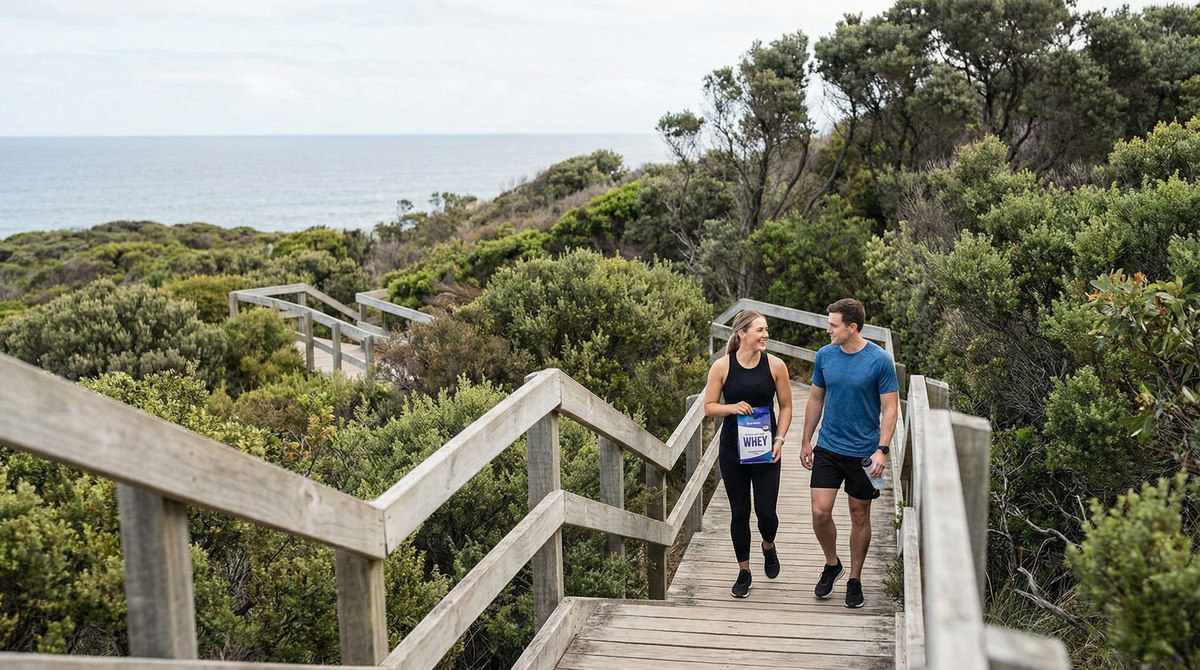 Two runners on a coastal boardwalk