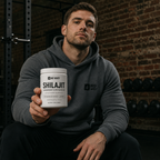 Athlete in a gym holding the NoWhey Shilajit 60-capsule tub - 500mg extract standardised to 40% fulvic acid